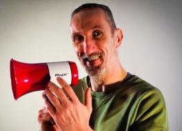 A man holding a megaphone and smiling