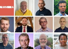 Eleven men and one woman smiling