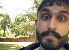 A close up of man's face in a park