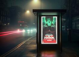 A bus stop advert at night, with traffic running past it