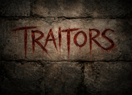 A stone wall with the words 'Traitors' scratched into it