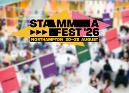 A logo saying 'STAMMAFest 2026' against a blurred picture of people seated at tables in a conference setting
