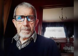 A man with a serious expression on his face