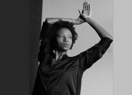 A woman with her arms in the air, looking to the side