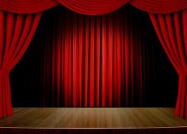An empty theatre stage, with its curtains open
