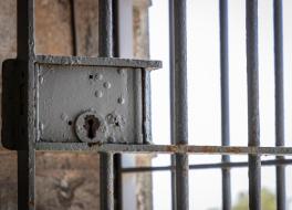 A lock on a prison barred door
