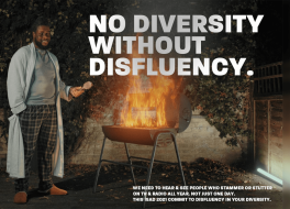 A man standing next to a barbecue that has flames coming out of it.