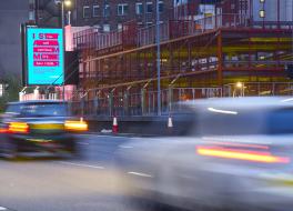 A busy road with an outdoor advertisement displaying the I Stammer campaign