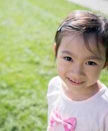 A young girl looking at the camera and smiling