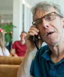 A man speaking into a telephone