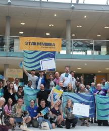 A group of people holding flags and waving