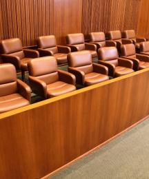 A juror's box with empty seats inside