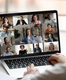 A person looking at a laptop computer, where a video call is taking place
