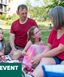 A mother and father having a picnic with two daughters, one young and one adolescent