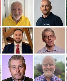 Eleven men and one woman smiling