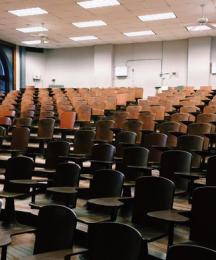 A lecture theatre full of empty chairs.