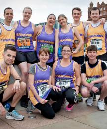A group of people in running costumes posing for the camera