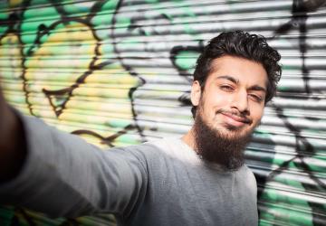 A young man taking a selfie photograph