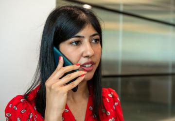 A woman speaking into a phone