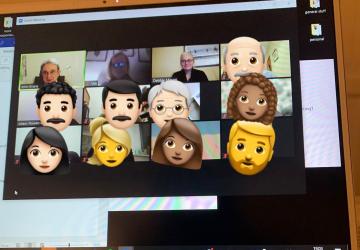 A computer screen with lots of emoji faces on it and a few people on a video call