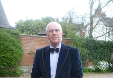 A man in an evening suit looking at the camera