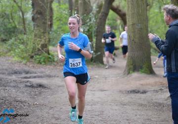 Libby Orrett running in the woods