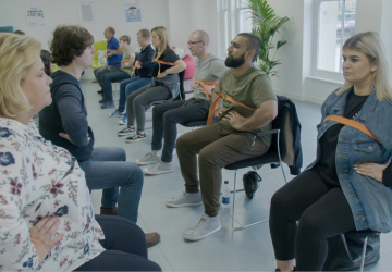 People sitting in a group therapy setting