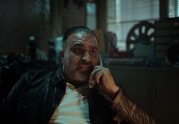 Still image from our Don't Hang Up. Hang On. film, a taxi rank dispatcher on the phone