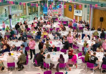 Wide view of the 16+ teams sitting at round tables at the STAMMAFest 2024 quiz