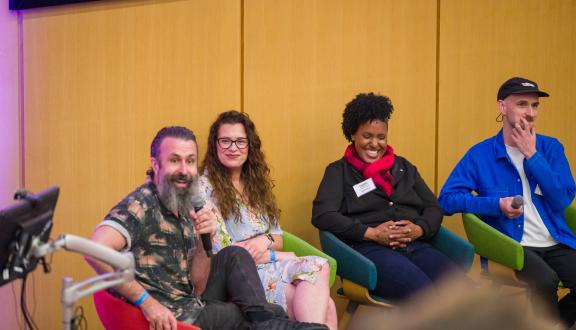 Scroobius Pip laughing while on Tribe panel at STAMMAFest 2024