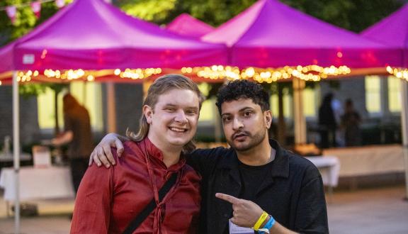 Two men stood smiling outside the conference venue