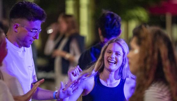 A group of young adults laughing outside the conference venue
