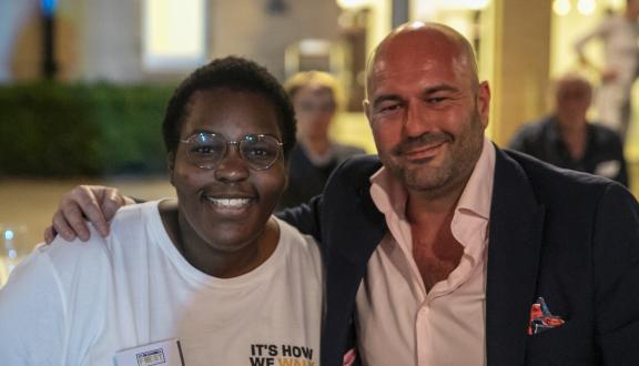 A woman and man smiling outside the conference venue