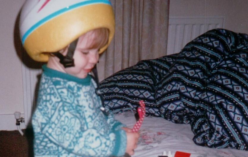 Poem: Name Your Fears A child wearing a crash helmet, playing with sunglasses