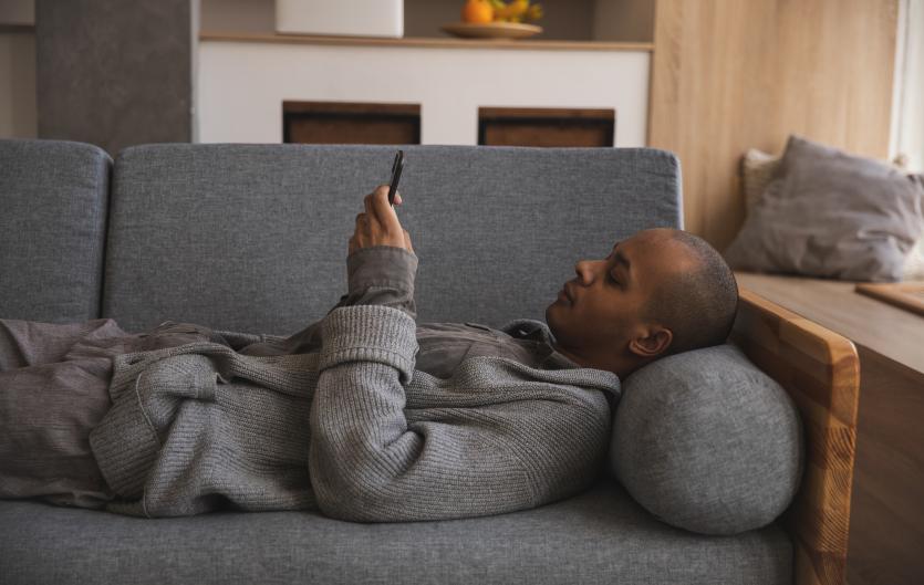 Webchat has launched Man lying on a sofa looking at his mobile phone
