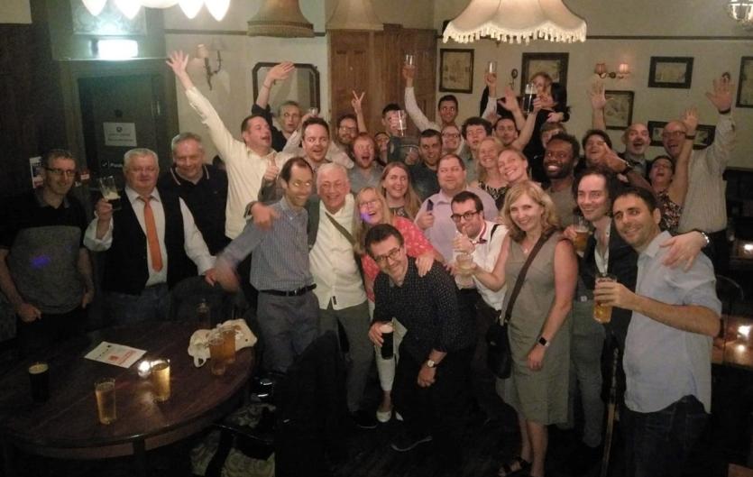 Punching through to 3,000 Members A group of people celebrating and looking at the camera