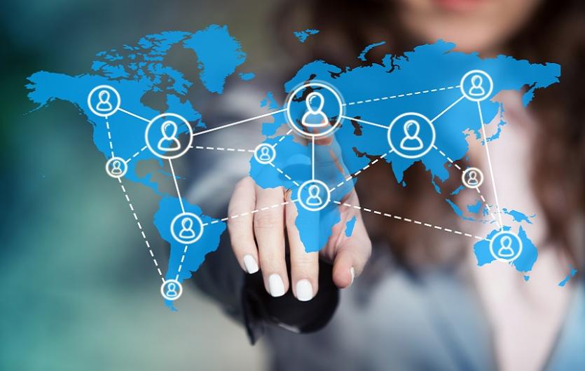 International Links A map of the world, with connecting lines crossing countries, and a woman's hand pointing to one of the countries