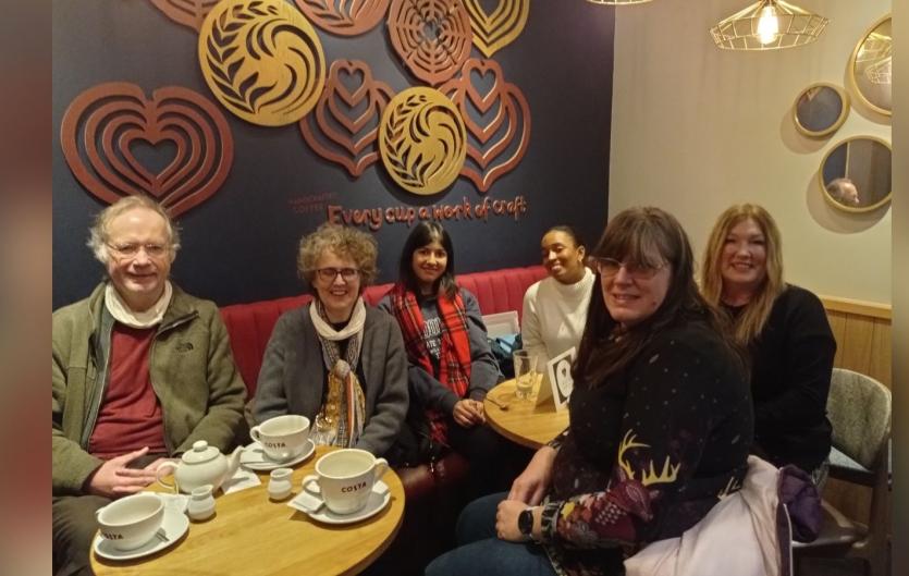 Coventry Stammerers A group of people sitting in a coffee shop looking at the camera
