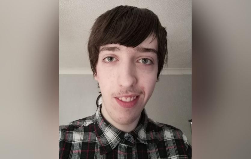 Poem: Equality for people who stammer A young man looking at the camera, smiling