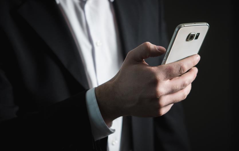Adventures in online dating A hand using a mobile phone
