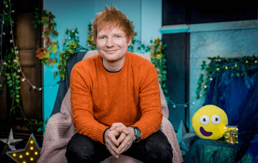 Ed Sheeran reads the CBeebies Bedtime story Ed Sheeran sitting on a chair looking at the camera