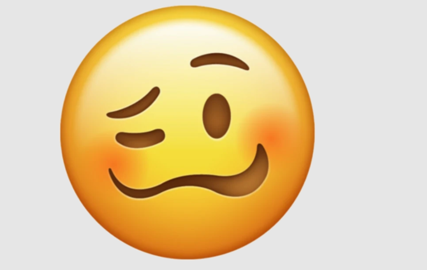 An emoji that with a crooked smile and a closed eye