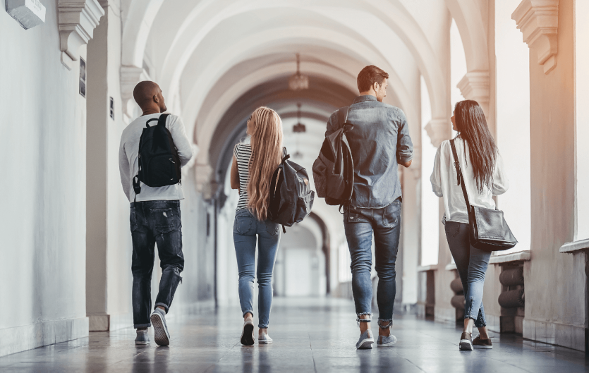 Freshers Week & Stammering The backs of four young people as they walk away, wearing backpacks