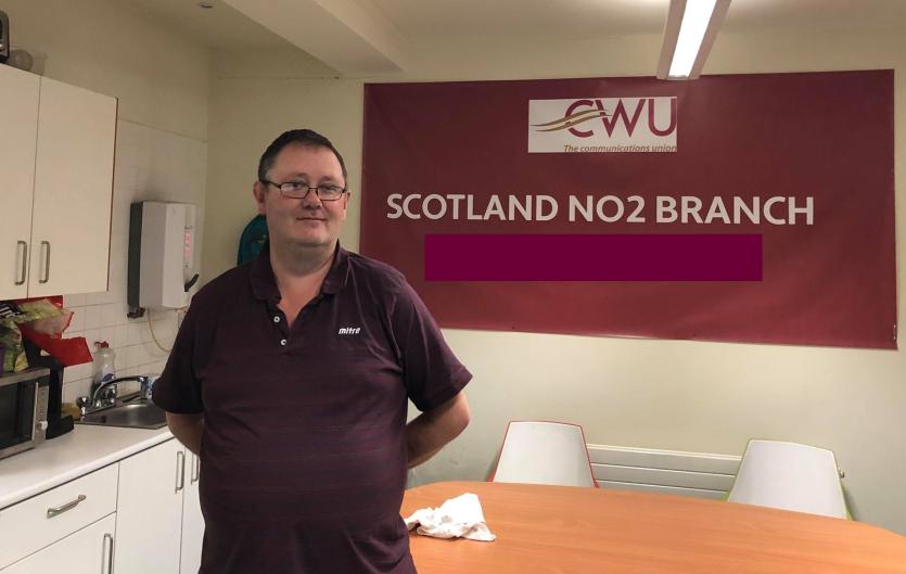 Gary Clark in a works kitchen. Signs say "CWU - the communications union" and "Scotland No.2 branch"