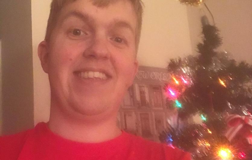 The gift that keeps on giving James Hayden next to a Christmas tree