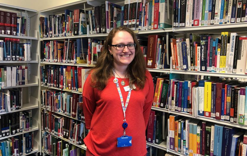 I quite enjoy giving presentations A woman in a library setting looking at the camera and smiling