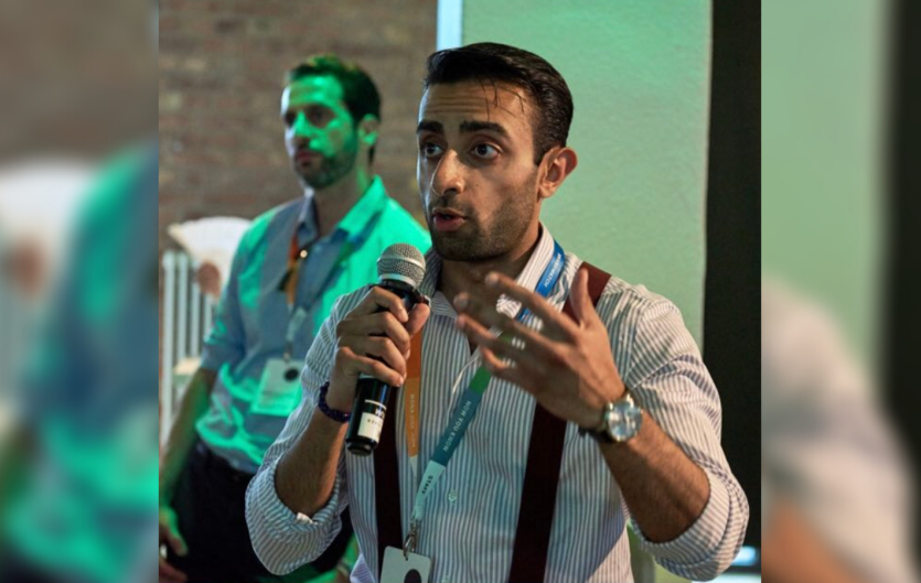 The article's author, Nasir Din, talking into a microphone