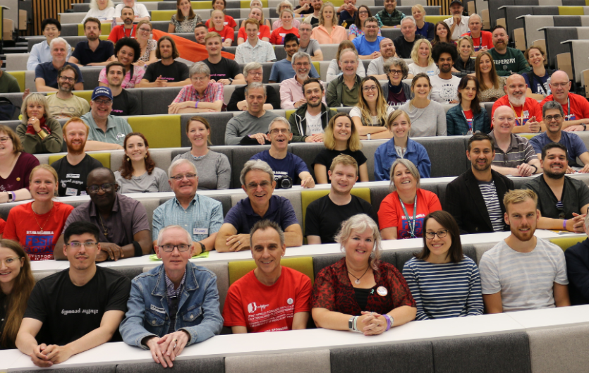 Trustee elections: Call for applicants A group of people sitting in a lecture theatre looking at the camera