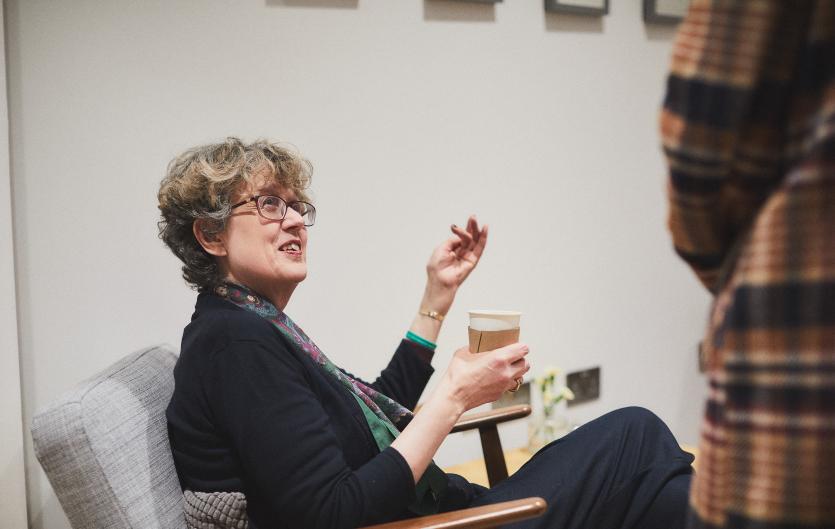 A Guide to Therapy Options A woman sitting on a chair talking to someone standing