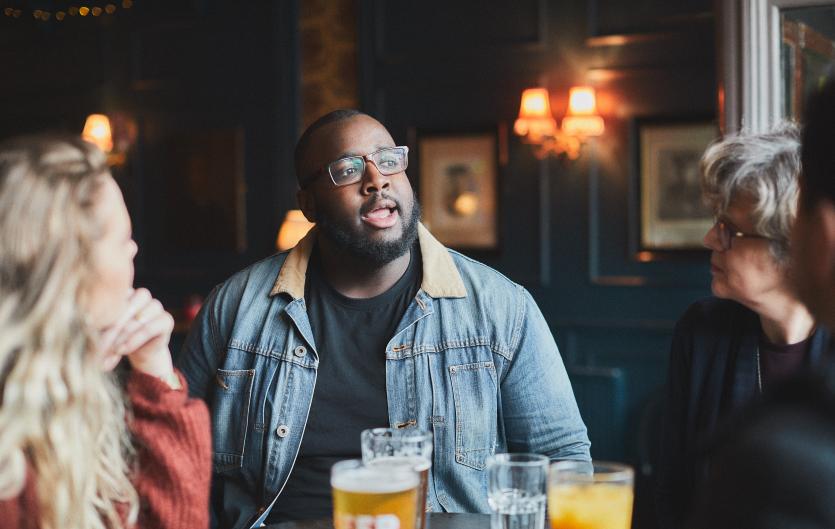 Man talking with friends in a pub